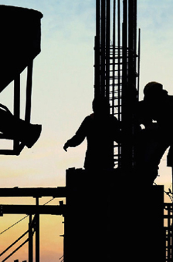 construction workers moving machinery on construction site
