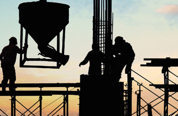 construction workers moving machinery on construction site