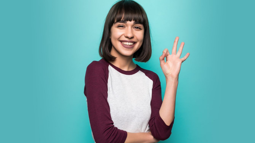 Woman Doing Ok Sign On Teal Background 820 X 460 Px (1)