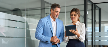 Business man and woman looking at tablet