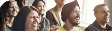 Image of employees at a townhall meeting announcement