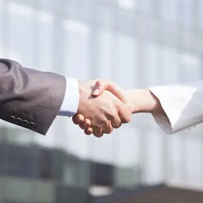 Business handshake representing client management and relationship building in legal services