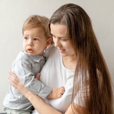 A white woman holding a baby 