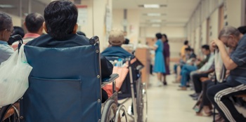 An illustrative photograph of poor patient flow leading to a busy hospital waiting room.