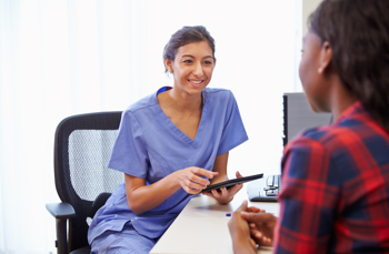 A nurse talking to a young woman
