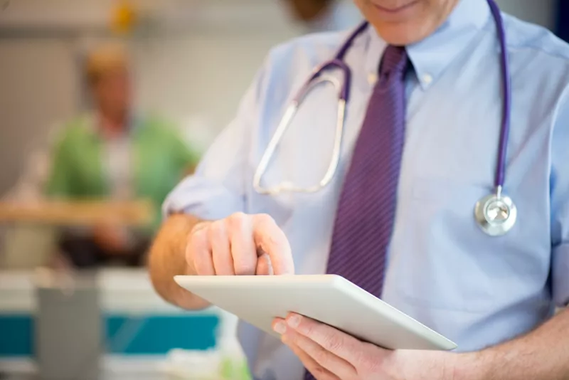 A hospital consultant entering information into an electronic health record.