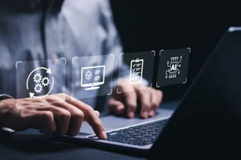 A man on a laptop with technology icon holograms.
