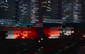 mobile phone with code in the background