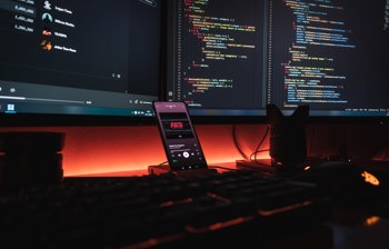 mobile phone with code in the background