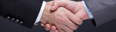 Accountants shake hands during accounting practice sale
