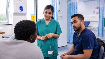 Two clinicians attending a patient in an Emergency Department.