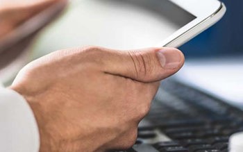 a pair of hands holding a tablet