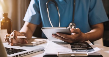 A nurse checking patient notes for a virtual ward.