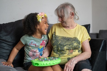 young child and older lady smiling at each other