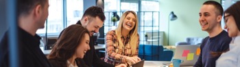 Image of a happy and laughing group of employees in the office