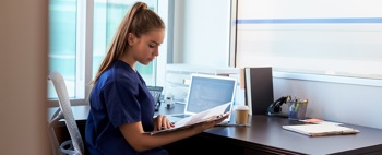 A nurse performing hospital management tasks.