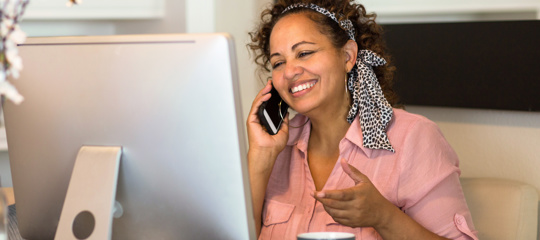 A woman smiling on her phone 
