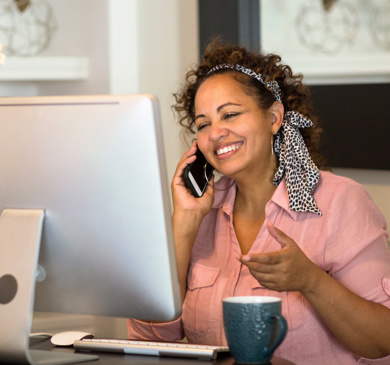 A woman smiling on her phone 