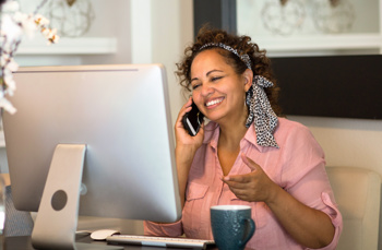 A woman smiling on her phone