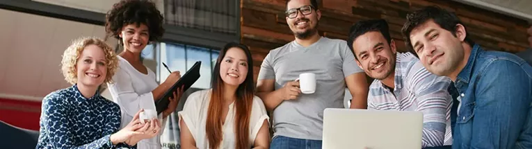 Stock image of employees posing for a photo
