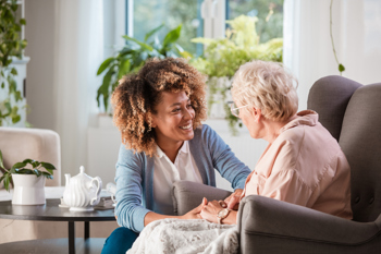 carer and elderly resident having a conversation