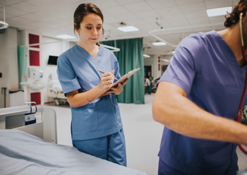 Nurse on a hospital ward checking notepad