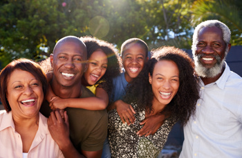 A black family smiling together 