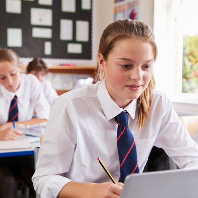 A school child writing something down