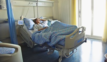 A patient in an NHS hospital bed.