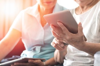 image of carer using tablet to deliver better quality social care