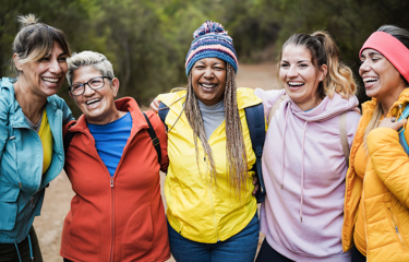 A group of women outside laughing together 