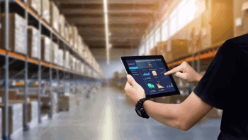 Image of a man in black shirt working on stock take using a tablet
